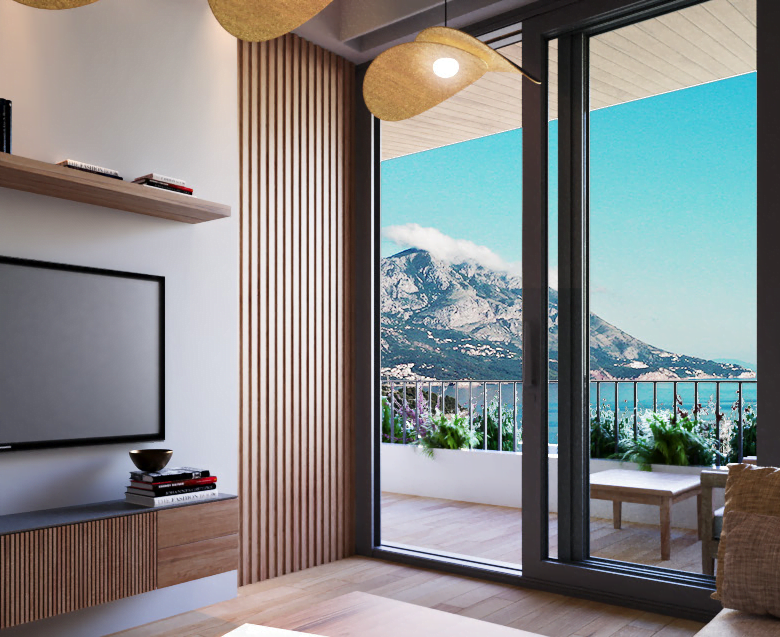 a room with a television and a view of the ocean