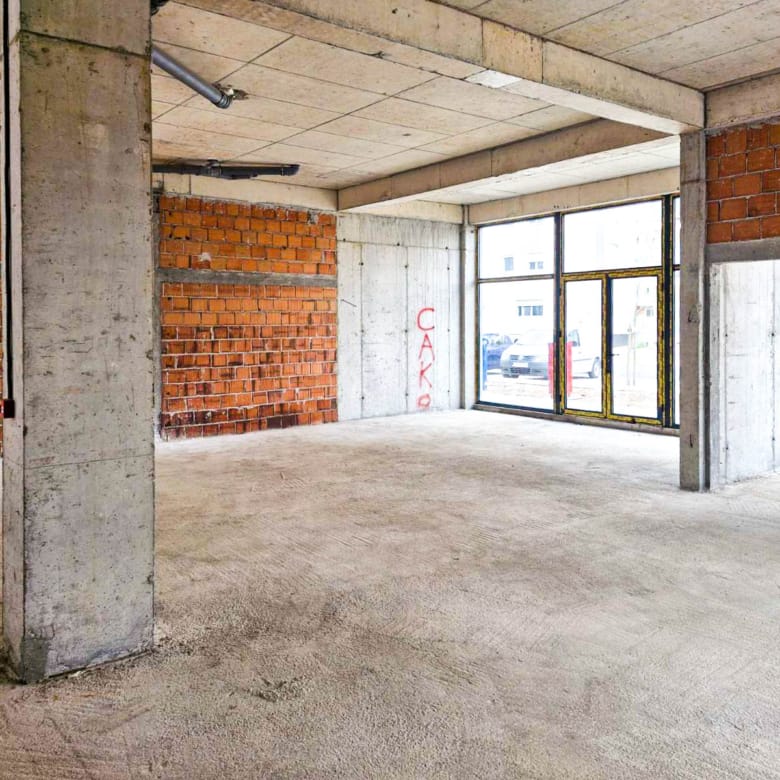 a room with concrete pillars and brick walls